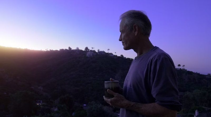 farmacy of light film - erik cutter with a cup of coffee
